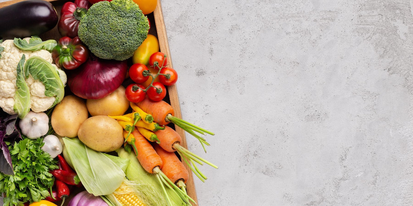 Wooden crate overflowing with fresh vegetables including broccoli peppers tomatoes and carrots.