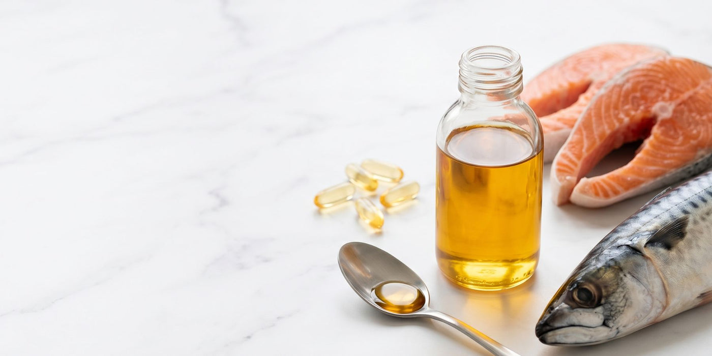 Bottle of fish oil with a spoon, salmon fillet and almonds on a marble surface