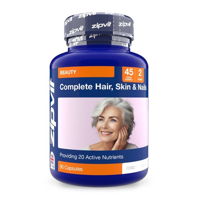 Blue bottle labeled Complete Hair Skin & Nails with a smiling woman on the label and 90 capsules