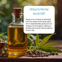 Glass bottle of hemp seed oil with cork stopper surrounded by hemp leaves and seeds on a wooden surface